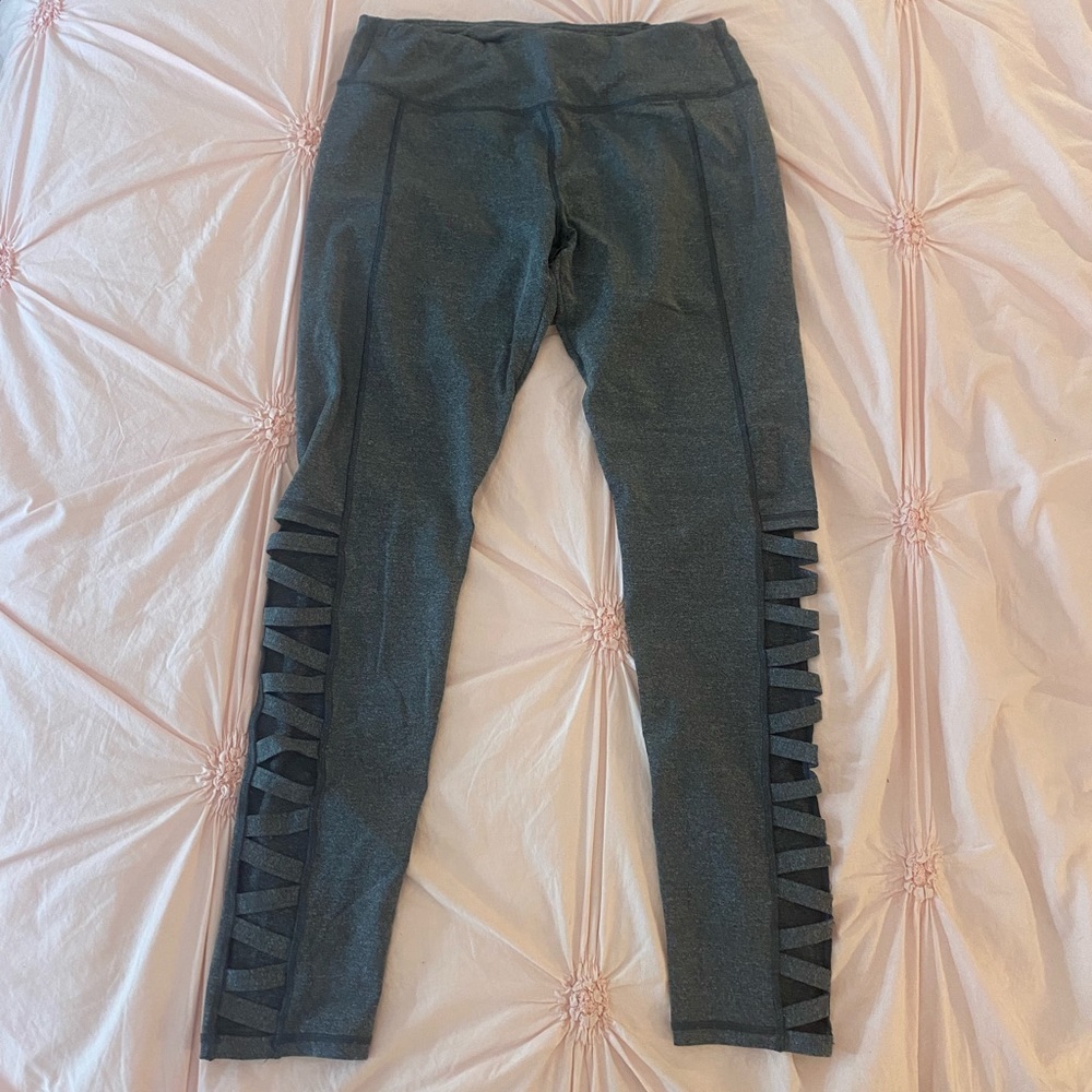 Grey leggings with open cut detailing at lower legs